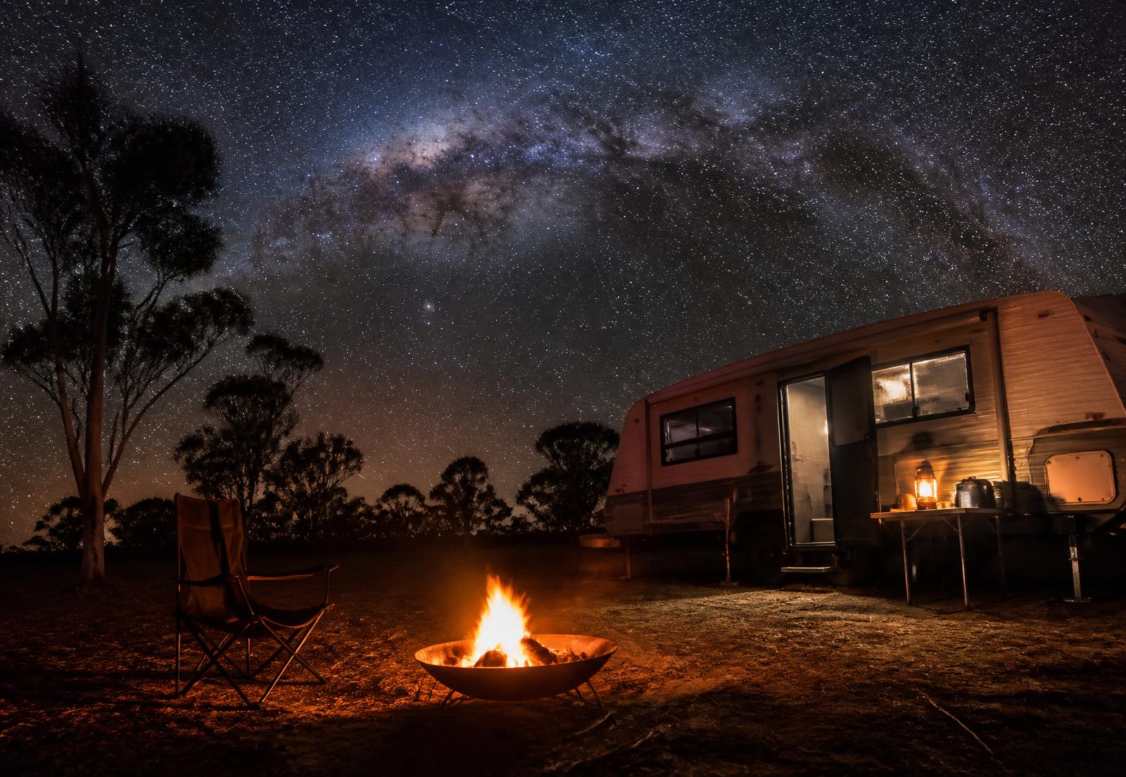 Campfire under a brilliant night sky