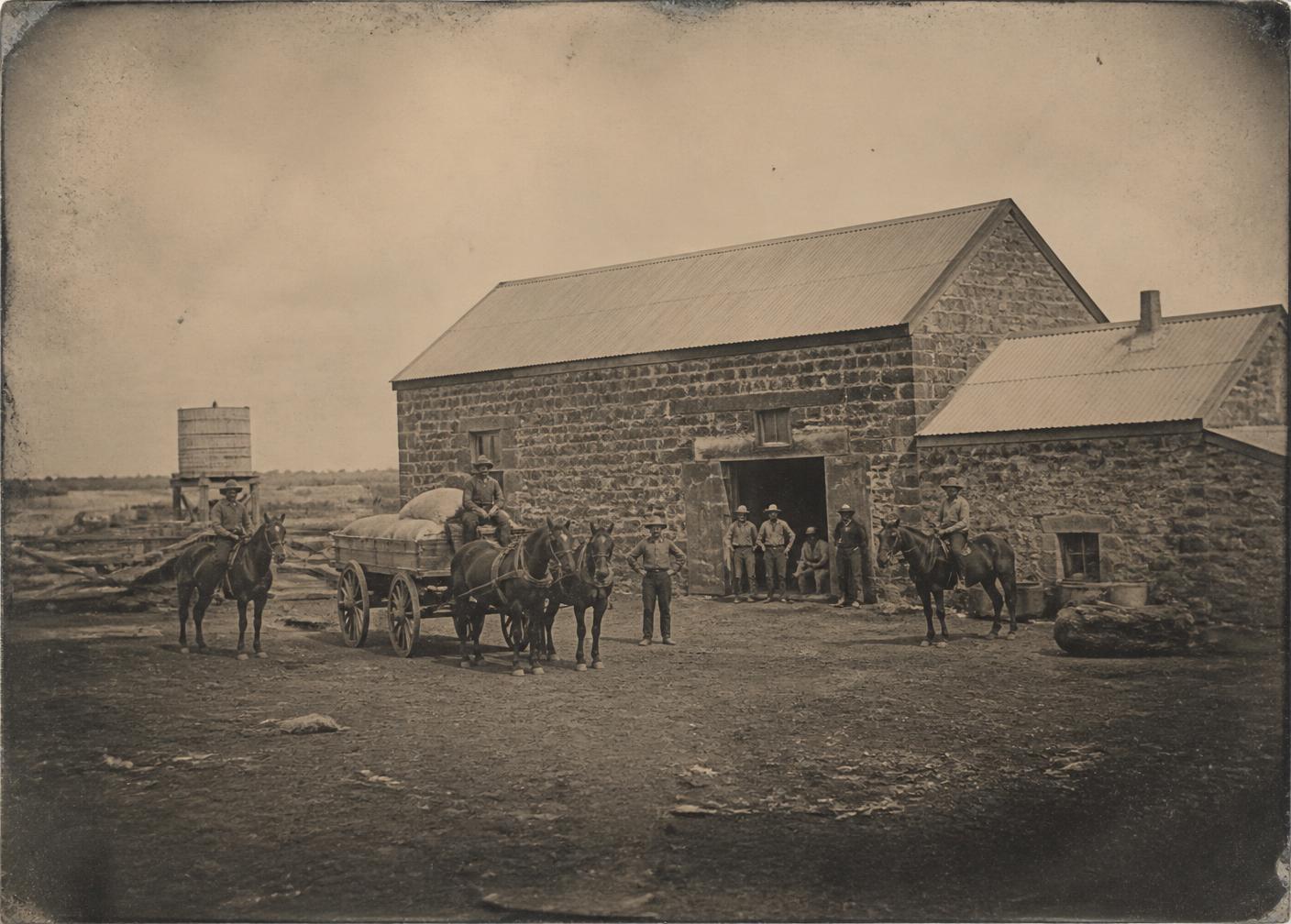 Archival photograph of station workers outside the stone shearing shed